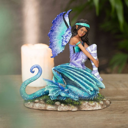 Dragon Perch Fairy Figurine by Amy Brown. Based on the ‘Dragon Perch’ watercolour painting by fantasy artist Amy Brown, this high-quality collectible fairy figurine features painted accents that perfectly capture every magical detail of the original artwork. Intricately sculpted and cast in resin, this purple and teal fairy sits atop her dragon companion, making it a perfect display piece for lovers of fantastical creatures and magical realms. Officially Licensed For Sale at Mrs Reed's Emporium & Atelier.
